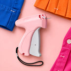 Pink Quick Stitch with blue, orange and pink garments, each held by a small clear fastener