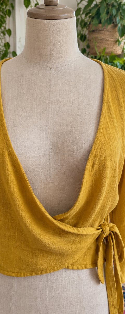Before: a mustard wrap top with the neckline falling open